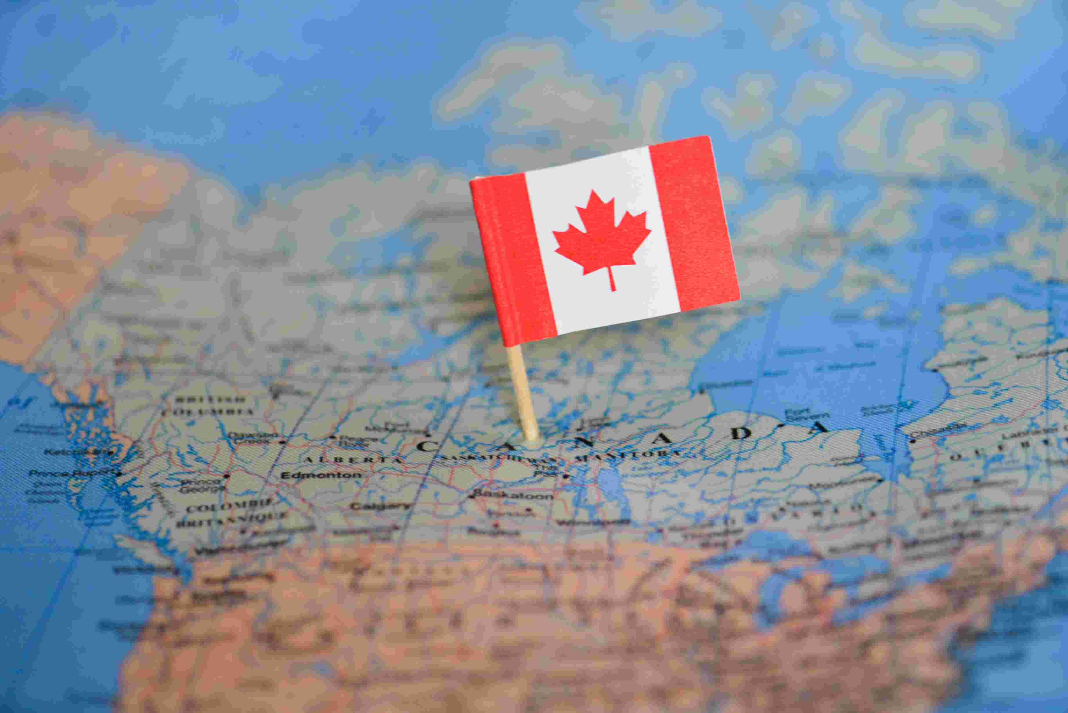 A map of Canada with a Canadian flag pinned to a remote community in northern Saskatchewan.