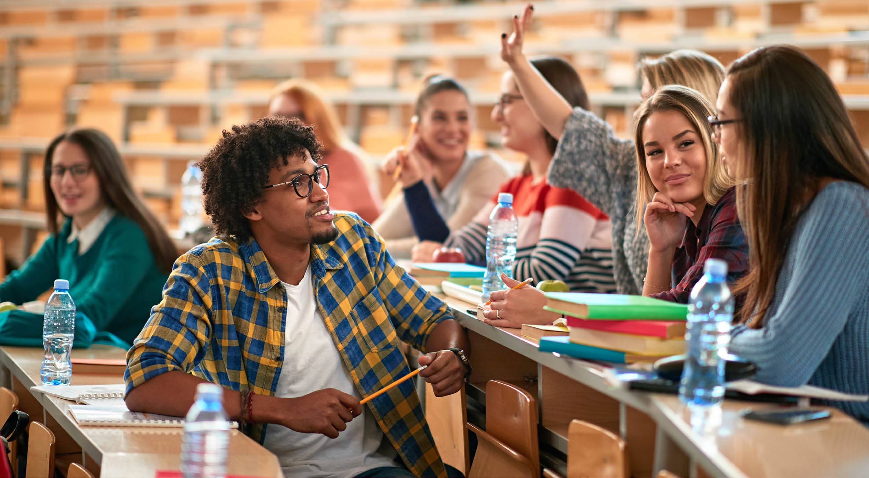 A diverse group of students studying in a lecture hall.