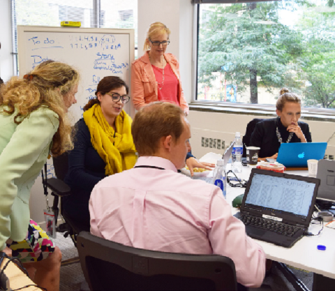 Assistant chief statisticians Sylvie Michaud and Monia Lahaie observe the work of employees at one of the many hackathons that took place in 2017/2018