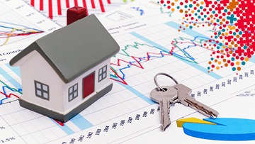 Housing market concept image with graph and toy house