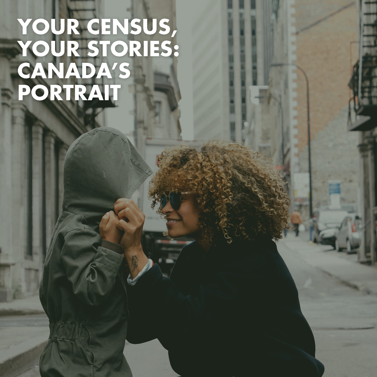 Woman and child holding hands in the street Text overlay says "Your census, your stories: Canada's portrait"